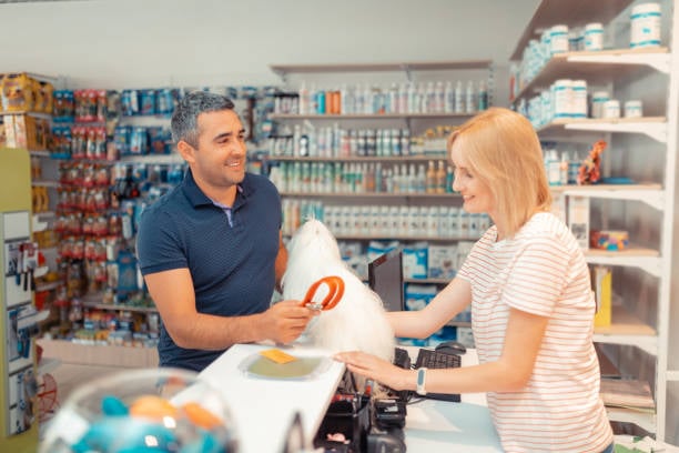 pet parent buying a new leash while picking up dog from pet-care business