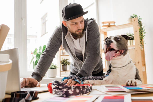 pet business owner picking out pet fashion samples with dog