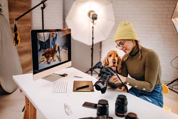 professional photographer reviewing photos with dog