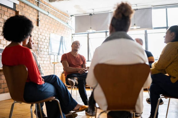 A group of people sit in a focus group.
