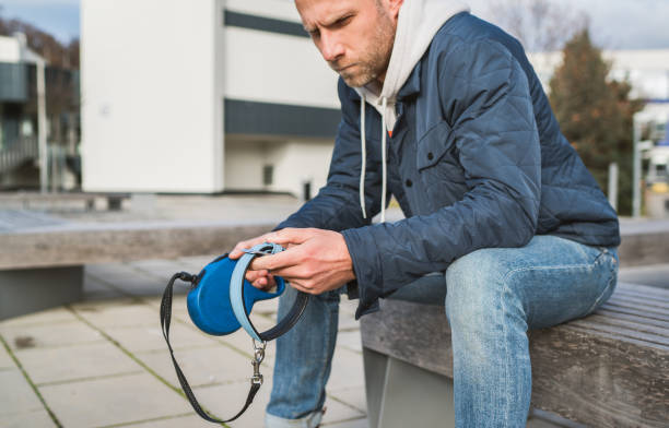 man holding leash waiting on a dog who never showed