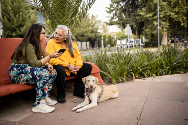 pet business owner showing pet parent how to use the mobile app with dog
