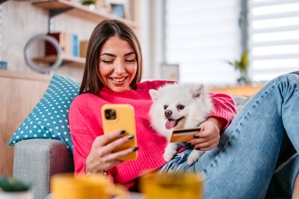 pet parent and dog paying for service on phone