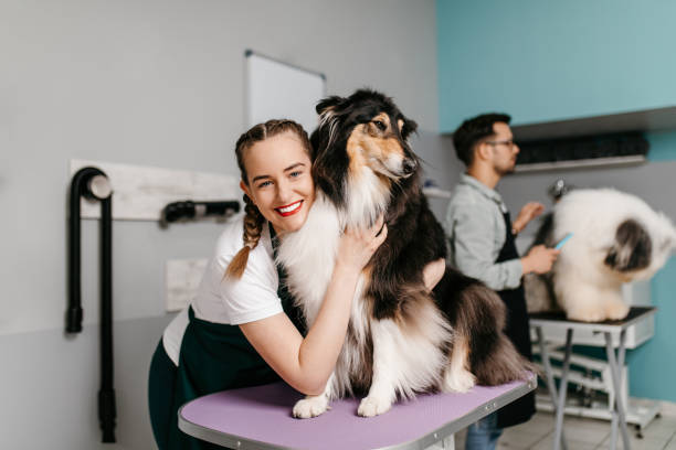 dog groomer hugging a sweet pup
