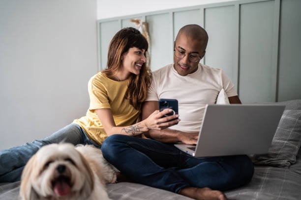 couple looking at pet report card on phone