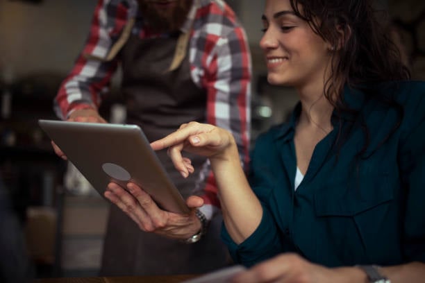 happy pet parent choosing reward on tablet