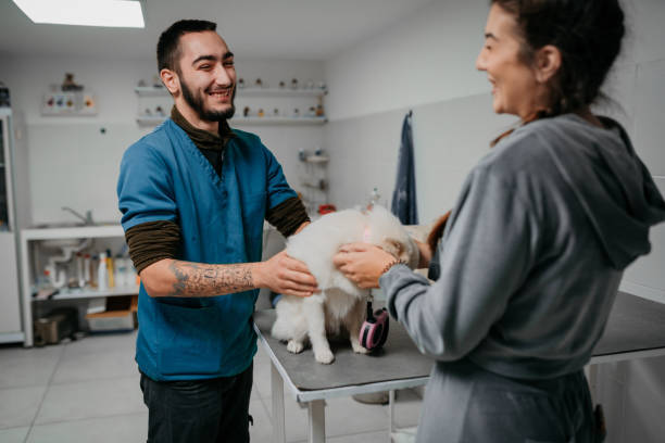 dog groomer and pet parent with little fluffy dog
