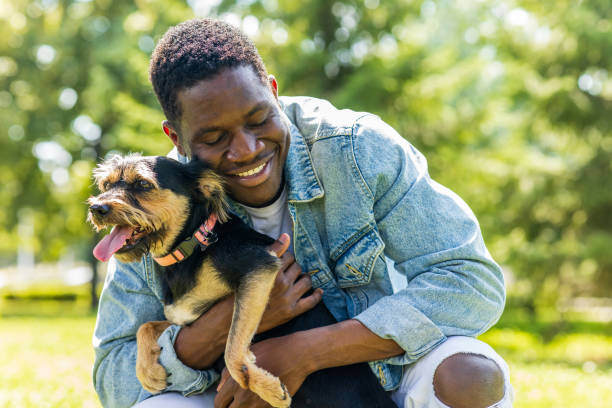 A man hugs a dog outside