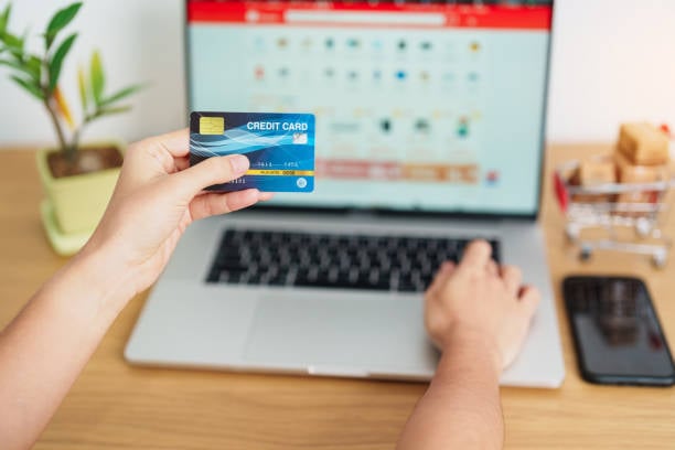 person adding credit card to online portal on laptop