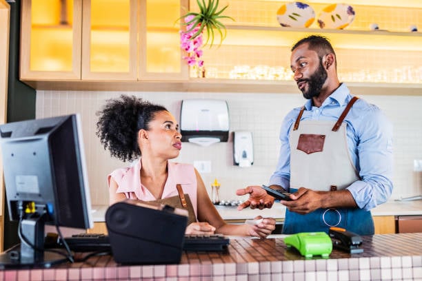 stressed grooming staff trying to reconcile payment at desk