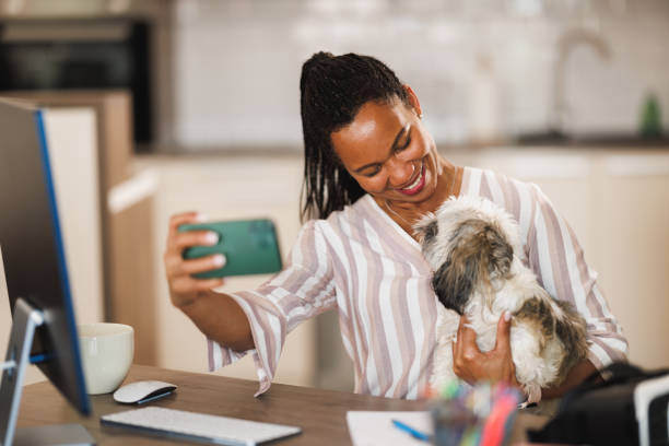 A woman takes a selfie photo with her dog