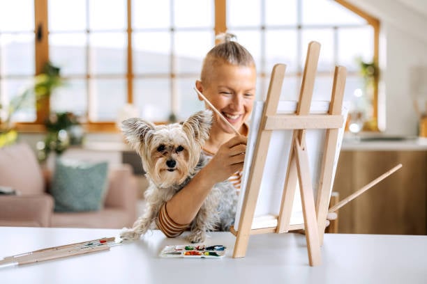 painting a pet portrait with dog in lap