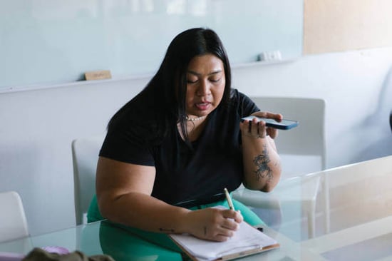 A woman translates using her phone