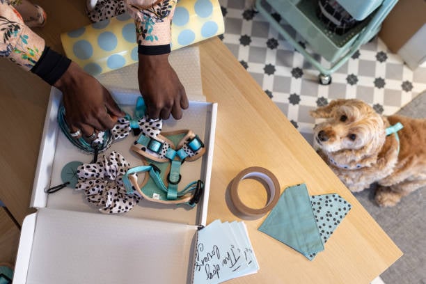 pet business boxing up a surprise gift of dog accessories for a vip client