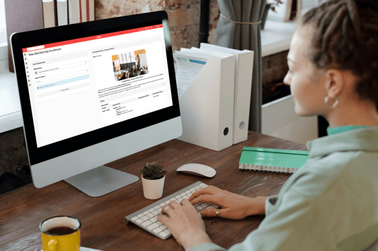 A woman using Gingr Memberships on a desktop computer.